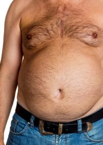 Mann mit Übergewicht. Symbolfoto für Bierbauch, Fettbrust und falsche Ernährung